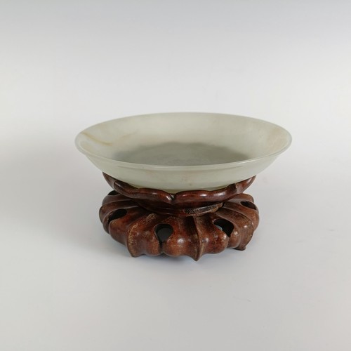 800 - A Chinese jade bowl, of shallow form, bearing a Chia-Ching (1796-1820) incised four character mark t... 