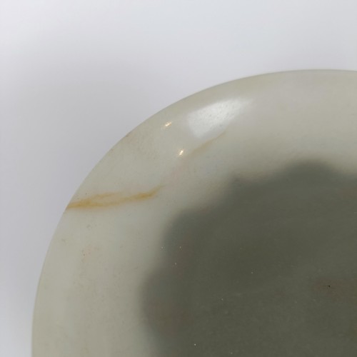 800 - A Chinese jade bowl, of shallow form, bearing a Chia-Ching (1796-1820) incised four character mark t... 