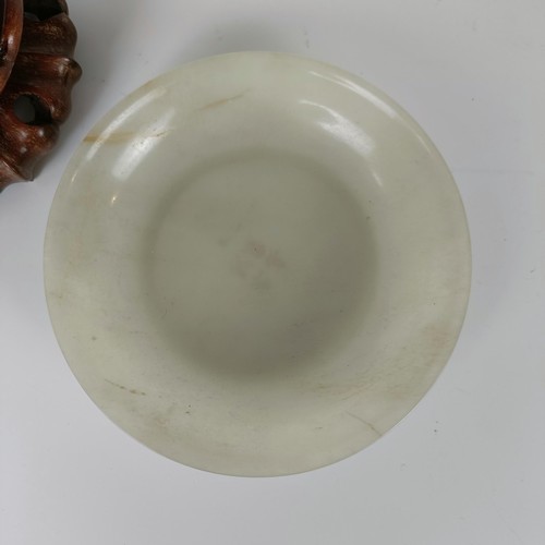 800 - A Chinese jade bowl, of shallow form, bearing a Chia-Ching (1796-1820) incised four character mark t... 