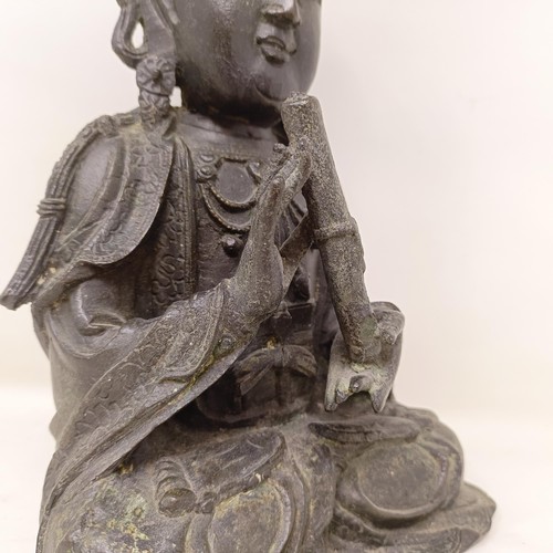 804 - A Chinese bronze Buddha, seated holding a scroll, 25 cm high