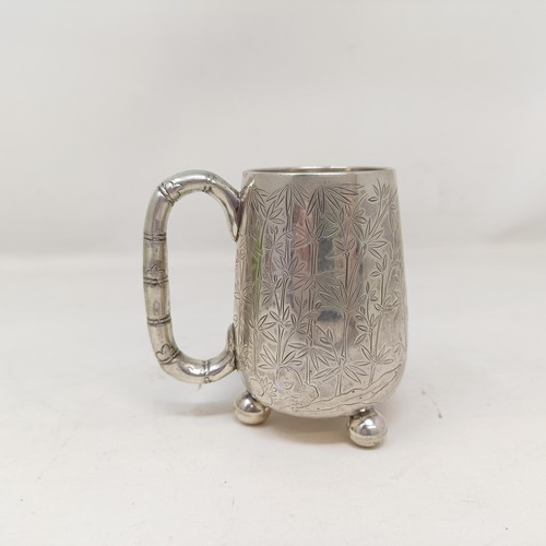 853 - A Chinese silver coloured metal christening mug, decorated bamboo, with a bamboo handle, and three b... 