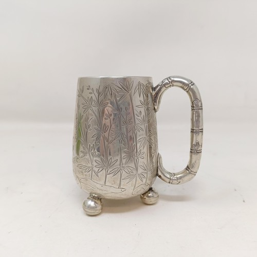 853 - A Chinese silver coloured metal christening mug, decorated bamboo, with a bamboo handle, and three b... 