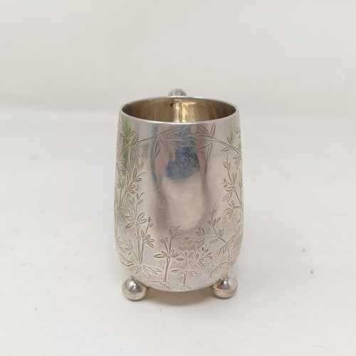 853 - A Chinese silver coloured metal christening mug, decorated bamboo, with a bamboo handle, and three b... 