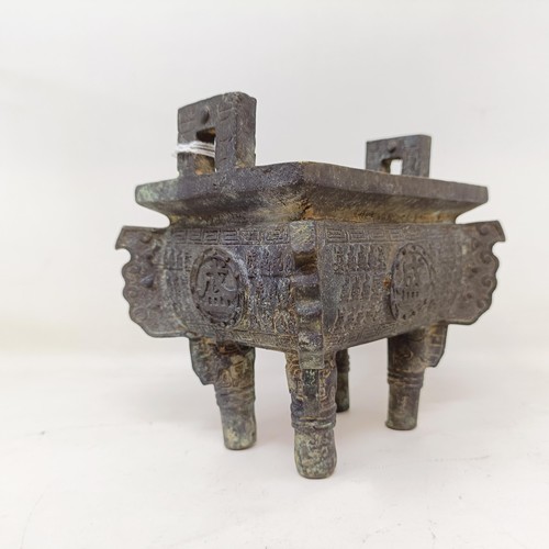 860 - A Chinese bronze censer, decorated figures and characters, on four legs, 14 cm wide