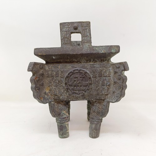 860 - A Chinese bronze censer, decorated figures and characters, on four legs, 14 cm wide