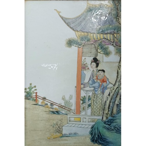 908 - A Chinese porcelain plaque, decorated figures, 36 x 25 cm, and its pair, in a modern frame (2)