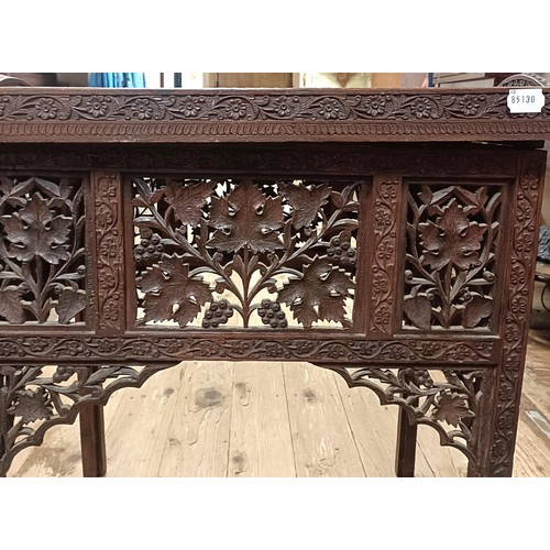 877 - A carved Indian tray top folding table, 61 cm wide