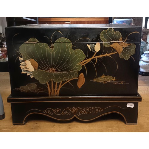 881 - A Japanese lacquered box, decorated bird perched on a branch, 56 cm wide