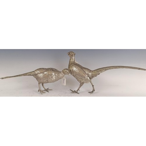 8 - A large Continental silver coloured metal cock pheasant, .835, 23 cm high, and a hen, 39.2 ozt (2)...