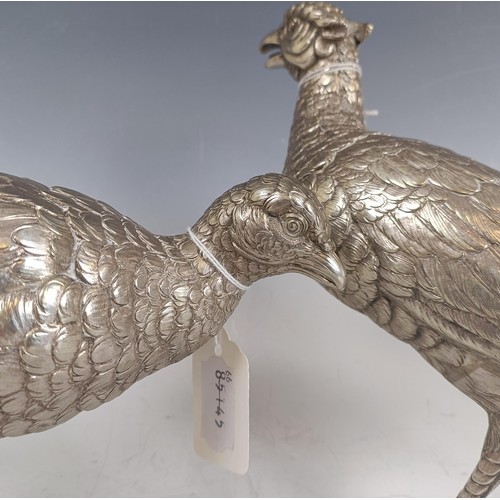 8 - A large Continental silver coloured metal cock pheasant, .835, 23 cm high, and a hen, 39.2 ozt (2)...