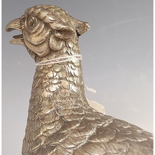 8 - A large Continental silver coloured metal cock pheasant, .835, 23 cm high, and a hen, 39.2 ozt (2)...