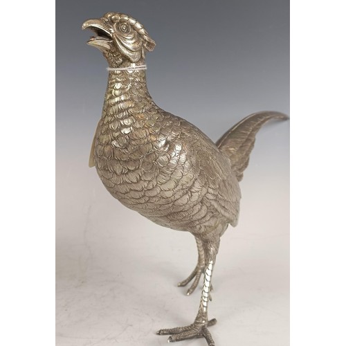 8 - A large Continental silver coloured metal cock pheasant, .835, 23 cm high, and a hen, 39.2 ozt (2)...