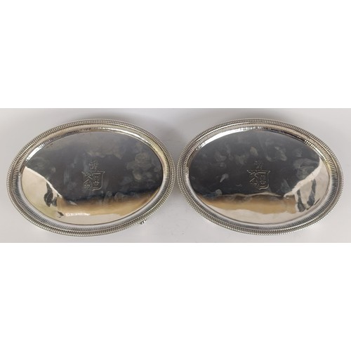 17 - A pair of George III oval silver salvers, crested, on four scroll feet, London 1801, 45.8 ozt, 29.5 ...