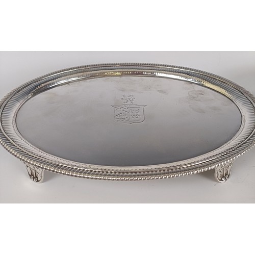 17 - A pair of George III oval silver salvers, crested, on four scroll feet, London 1801, 45.8 ozt, 29.5 ...