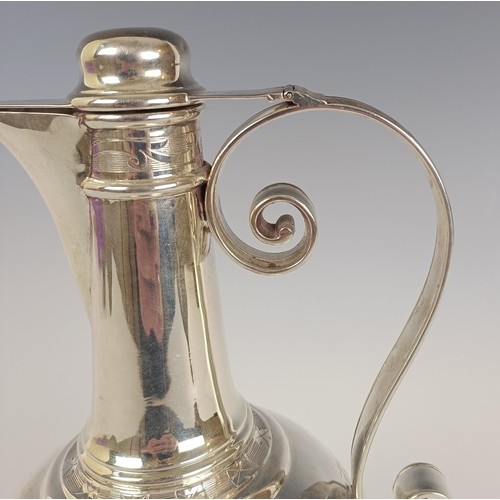 18 - A Victorian silver ewer, in the Russian taste, with engraved decoration and presentation inscription...