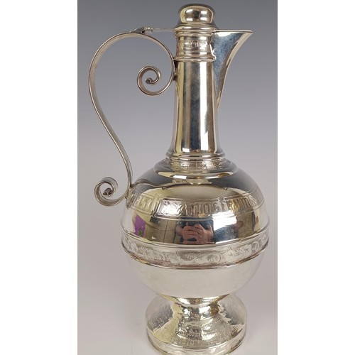 18 - A Victorian silver ewer, in the Russian taste, with engraved decoration and presentation inscription...