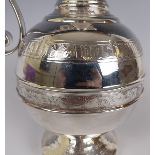 18 - A Victorian silver ewer, in the Russian taste, with engraved decoration and presentation inscription...