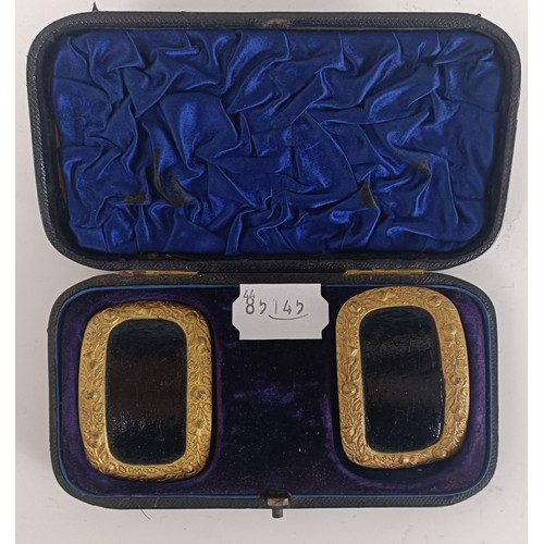 53 - A pair of silver coloured metal and leather shoe buckles, and another pair similar, both cased (2)