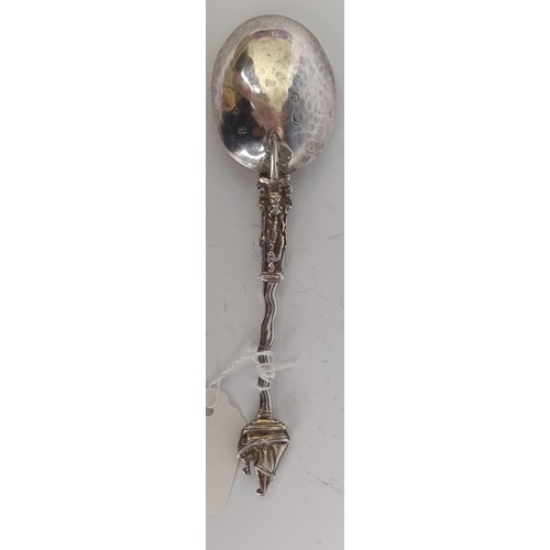 56 - A Continental silver coloured metal and gilt spoon, with a ship finial, 19 cm...