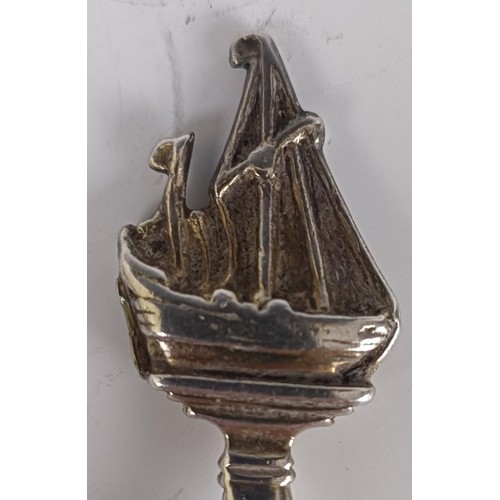 56 - A Continental silver coloured metal and gilt spoon, with a ship finial, 19 cm...