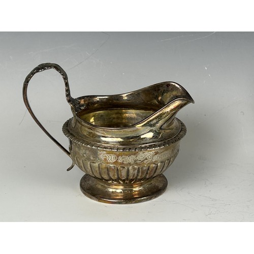 100 - A 19th century silver cream jug, marks rubbed, and a baby's push and spoon, cased, 8.2 ozt (2)