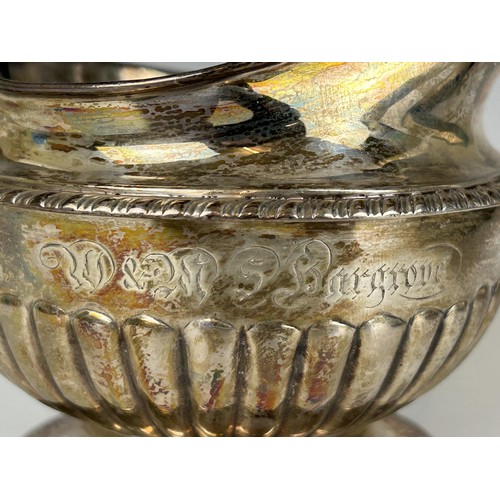 100 - A 19th century silver cream jug, marks rubbed, and a baby's push and spoon, cased, 8.2 ozt (2)