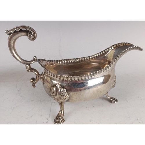 114 - A pair of George III silver sauceboats, initialled, with a crimped rim, scroll handles, and three ho... 