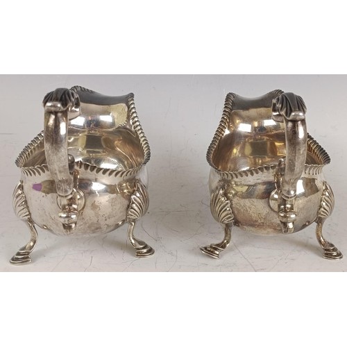 114 - A pair of George III silver sauceboats, initialled, with a crimped rim, scroll handles, and three ho... 