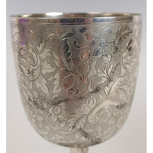 119 - A 19th century silver coloured metal goblet, initialed and dated 1863, with floral decoration, appar... 