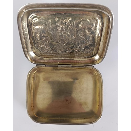 129 - A George V silver table snuff box, the lid embossed a tavern scene, London 1916, 8.0 ozt, 11 cm wide