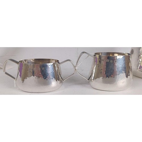 134 - A Elizabeth II silver four piece tea set, with hammered decoration and engraved a bushel of wheat, c... 