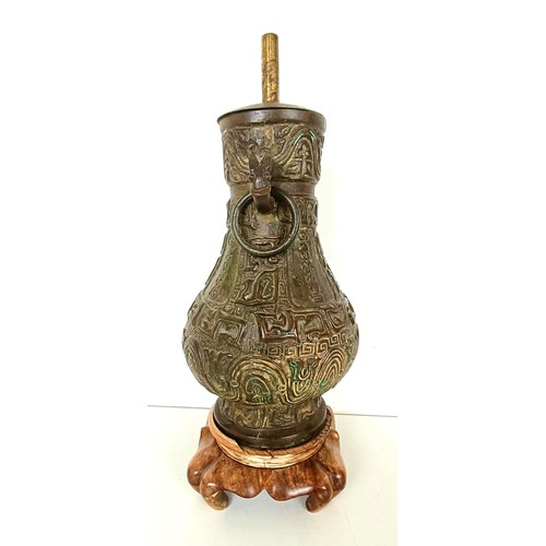 962 - A Chinese bronze vase, with ring handles, 30 cm high, on a wooden base, converted to a lamp