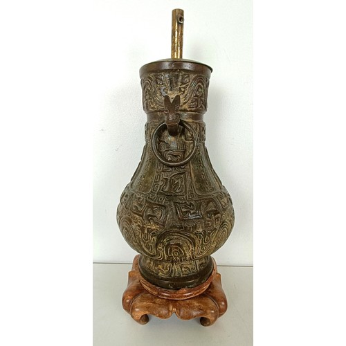 962 - A Chinese bronze vase, with ring handles, 30 cm high, on a wooden base, converted to a lamp