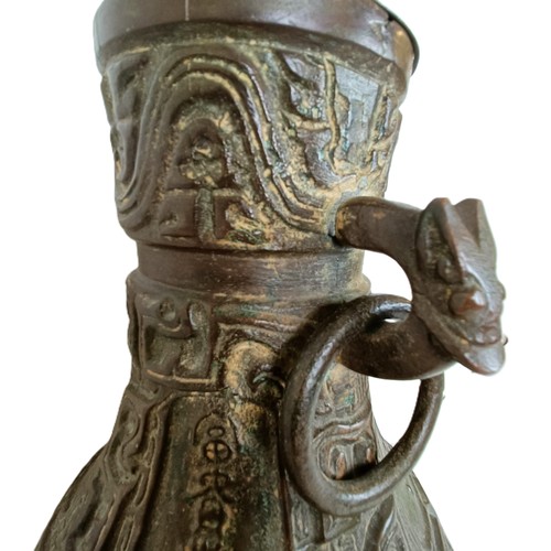 962 - A Chinese bronze vase, with ring handles, 30 cm high, on a wooden base, converted to a lamp