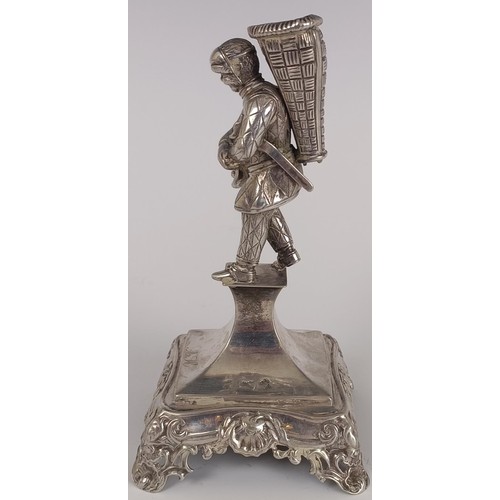 136 - A rare Portuguese silver coloured metal figural toothpick holder, on a square base, 13.5 cm high