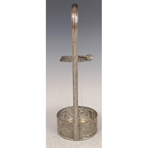 143 - A Continental silver coloured metal wine bottle holder, with a reeded handle and pierced decoration,... 