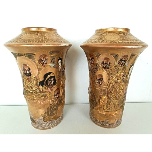 952 - A pair of Japanese vases, decorated figures, highlighted in gilt, 24 cm high