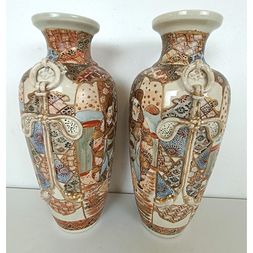 951 - A pair of Japanese vases, decorated figures, highlighted in gilt, 32 cm high (2)