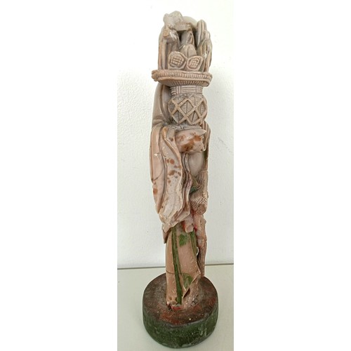 958 - A Chinese hardstone carving of a man, 25 cm high