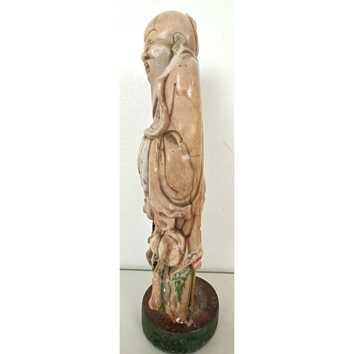 958 - A Chinese hardstone carving of a man, 25 cm high