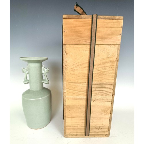 986 - A Chinese celadon vase, in a wooden case, 27 cm high