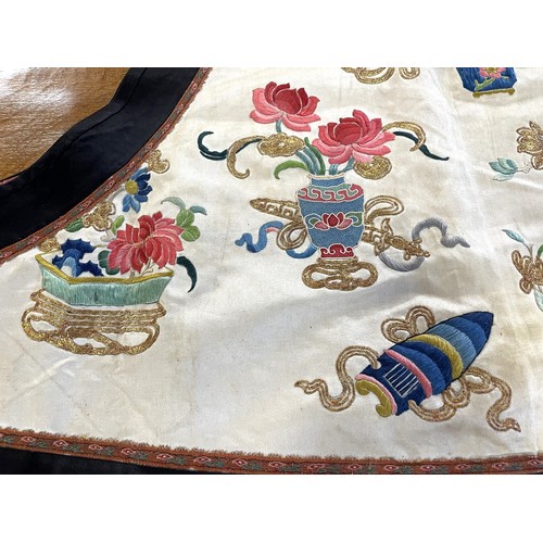 890 - A Chinese silk embroidered sleeveless jacket, decorated vases, flowers and other motifs