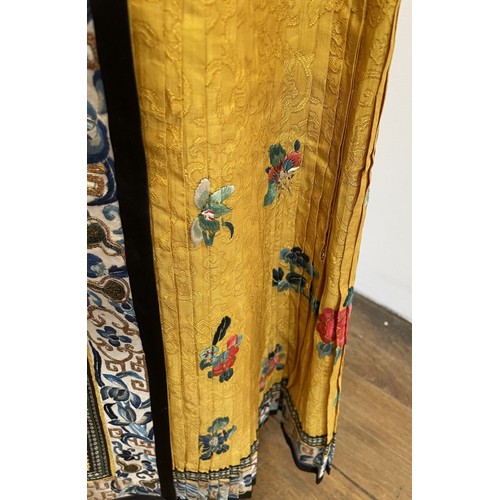 891 - A Chinese silk embroidered skirt, decorated flowers, on a yellow ground