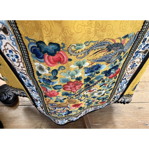 891 - A Chinese silk embroidered skirt, decorated flowers, on a yellow ground