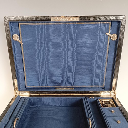 2 - A late Victorian leather travelling box, with various compartments, unusually with silver mounts, in... 