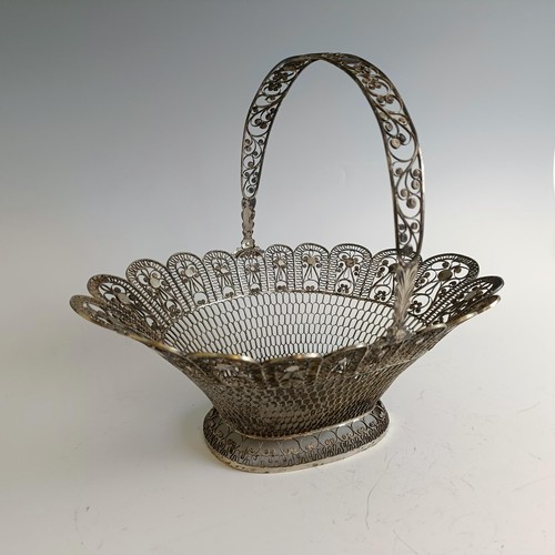 9 - A silver coloured metal filigree basket, 29 cm wide...