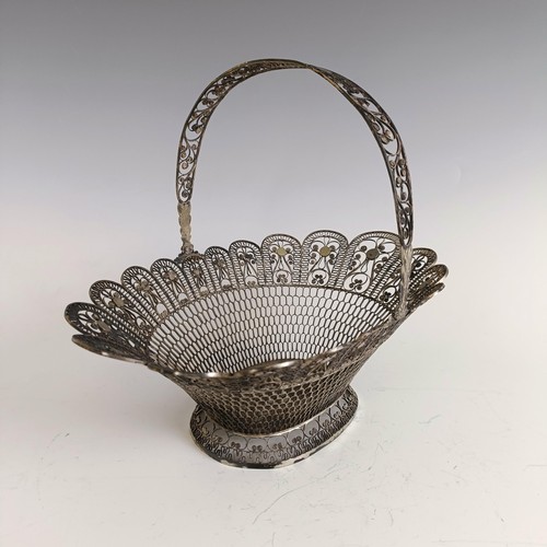 9 - A silver coloured metal filigree basket, 29 cm wide...