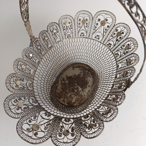 9 - A silver coloured metal filigree basket, 29 cm wide...