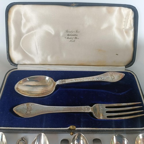 98 - A silver christening spoon and fork set, initialled, Sheffield 1935, cased, a silver jug, and other ... 