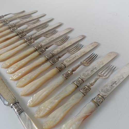 99 - A matched set of twelve silver plated dessert knives and forks, with silver collars and carved mothe... 